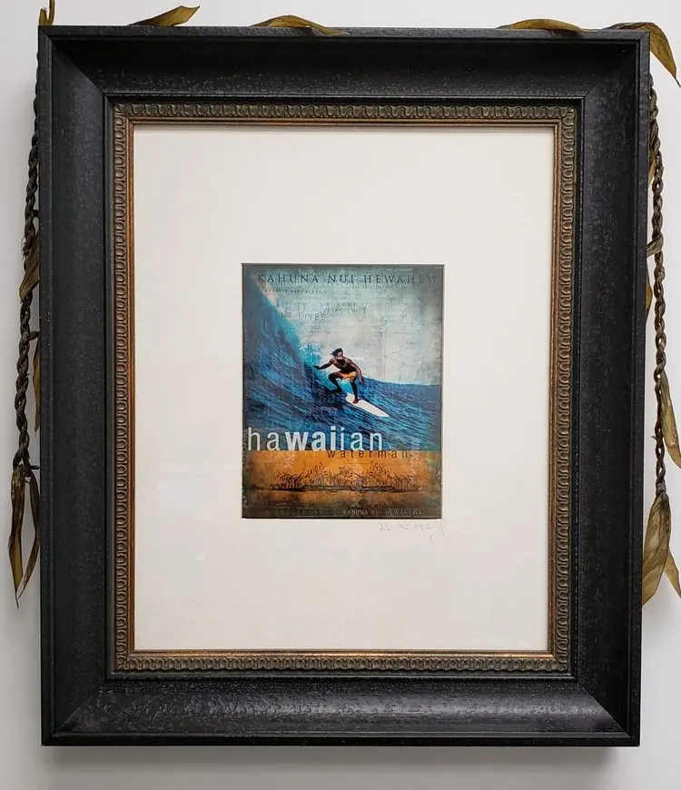 A framed Hawaiian surf print in the office.